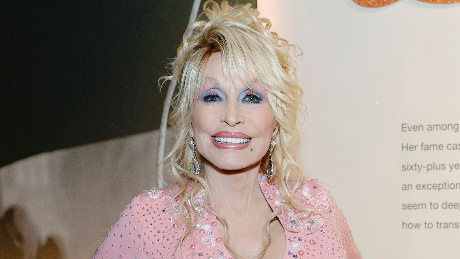 photo of dolly parton in pink outfit at country music hall of fame nashville