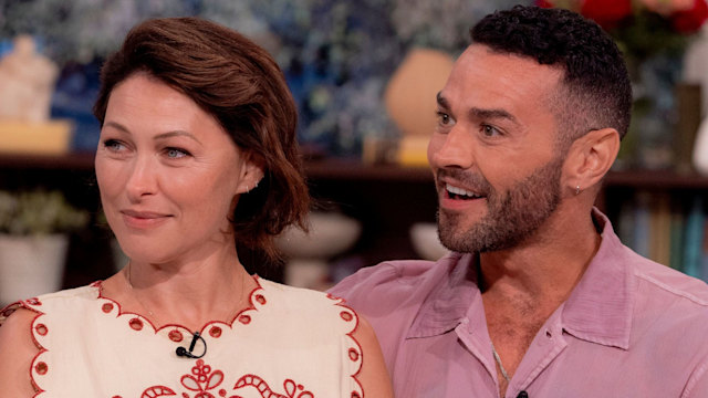 Emma Willis in a red and white top smiling next to Matt Willis