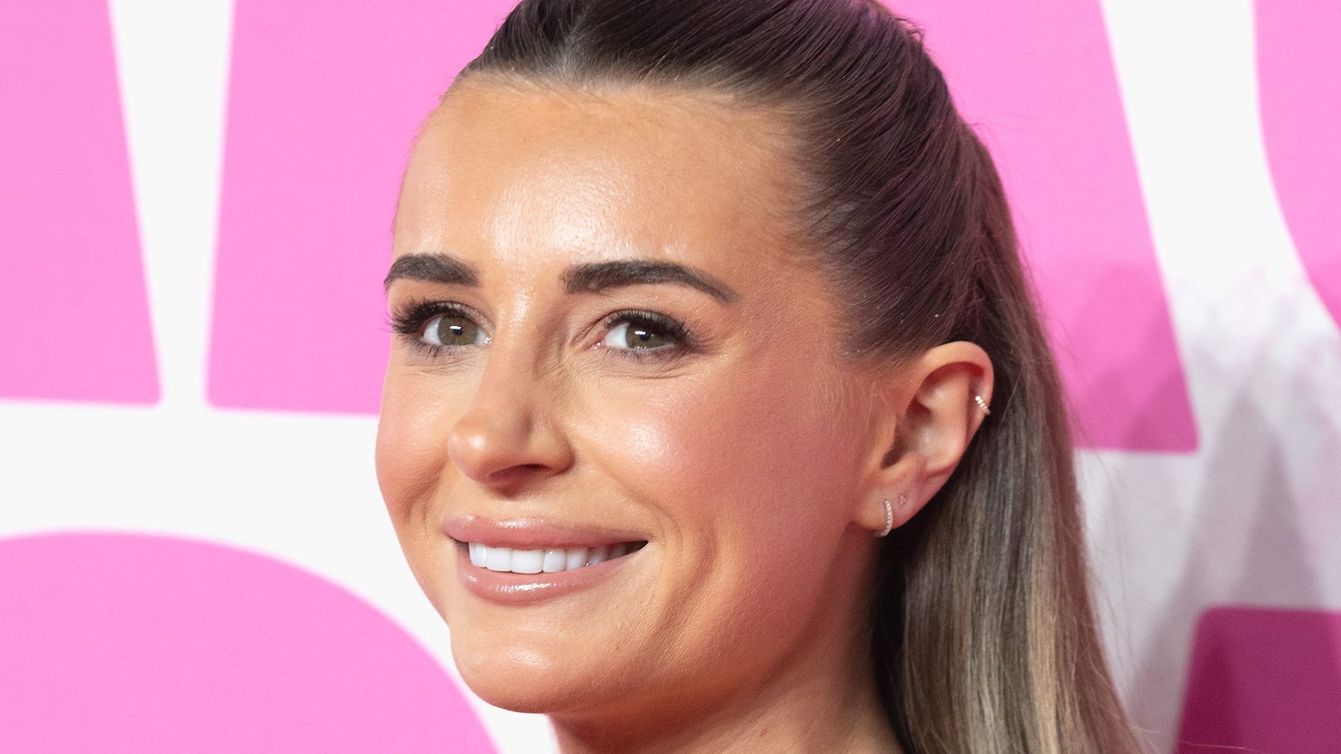 Dani Dyer up close in black strapless dress