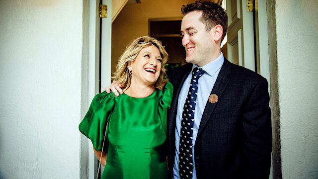 Man and woman smiling in formal wear