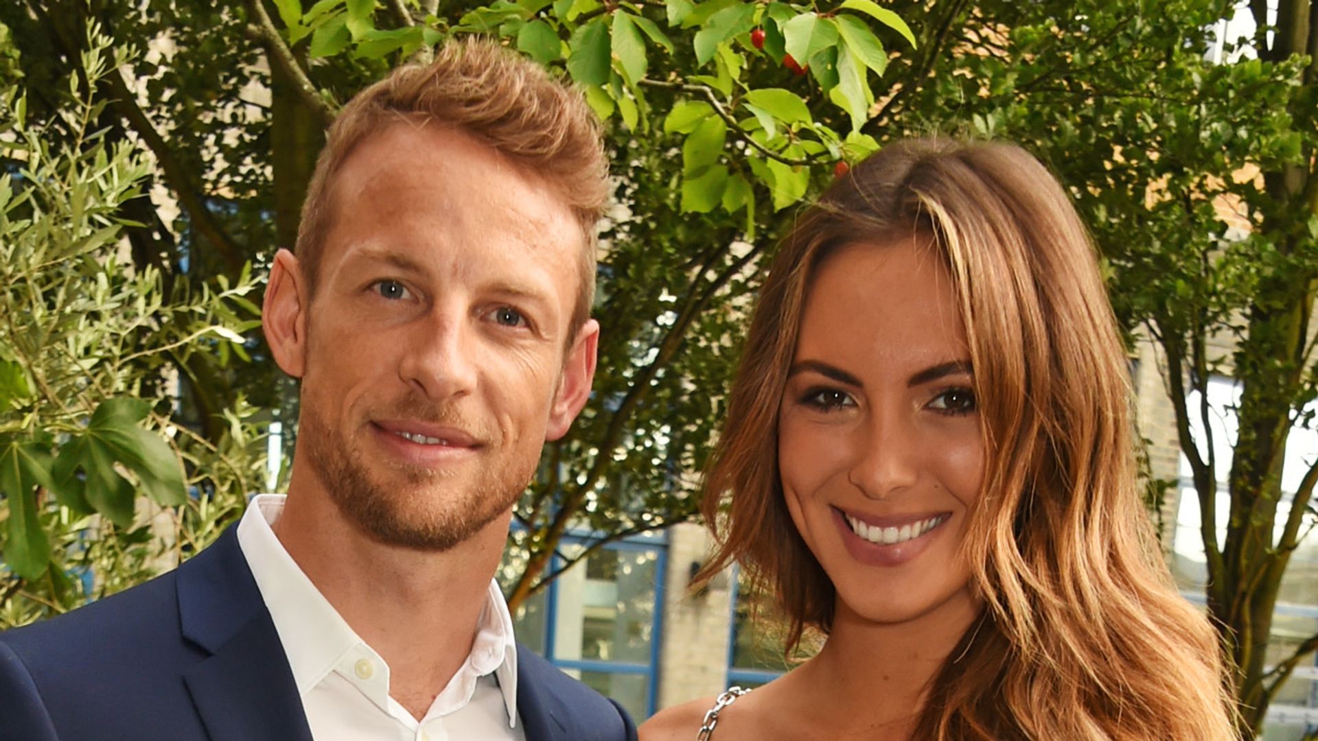 Jenson Button (L) and Brittny Ward pose outside