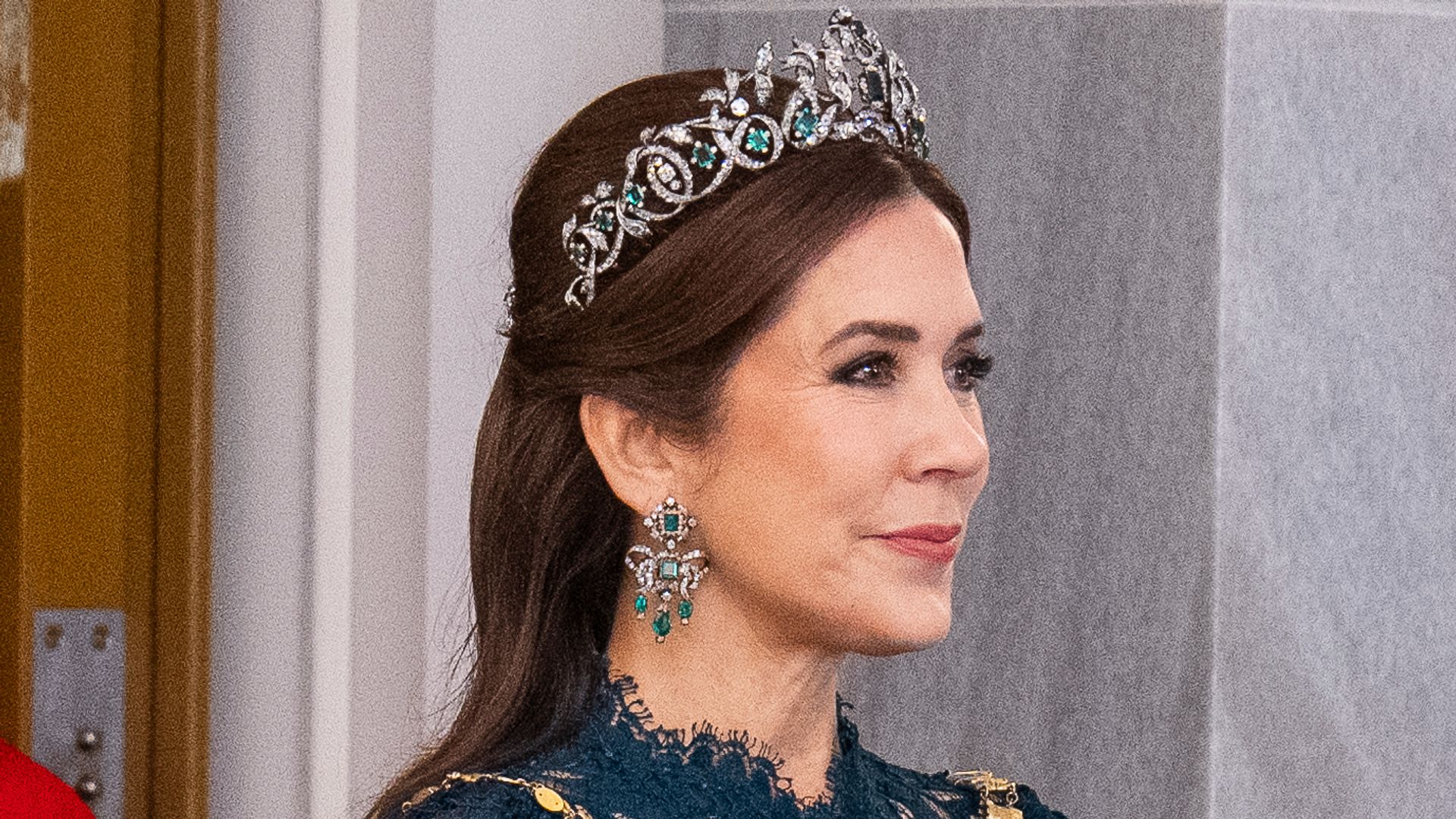 Queen Mary is a vision in glittering emerald tiara and sheer lace gown