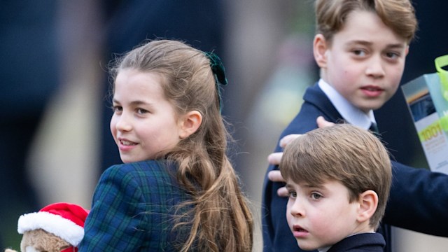 Prince George, Princess Charlotte and Prince Louis looking over their shoulders in blue coats