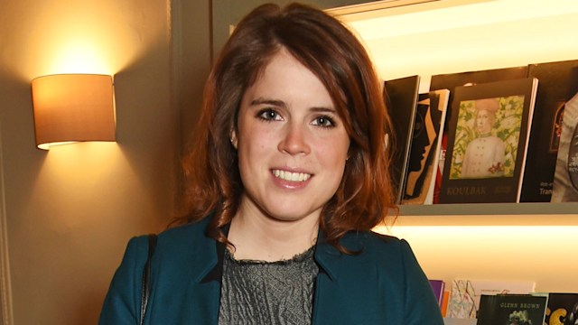 Princess Eugenie in a blue coat next to a lamp and vinyl records