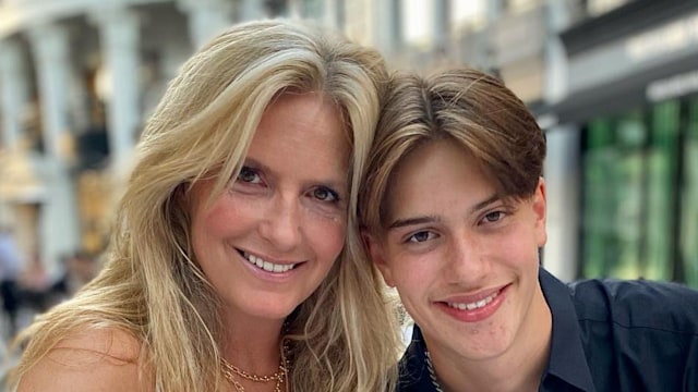 mother posing at restaurant with son 