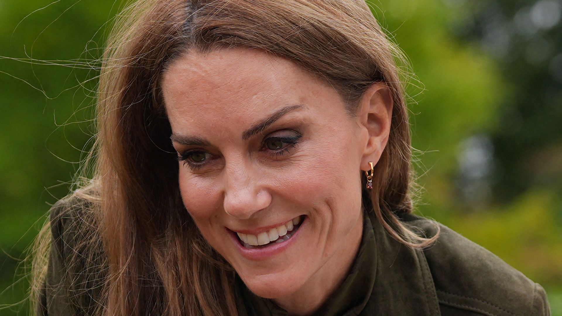  Catherine sitting on grass talking to child