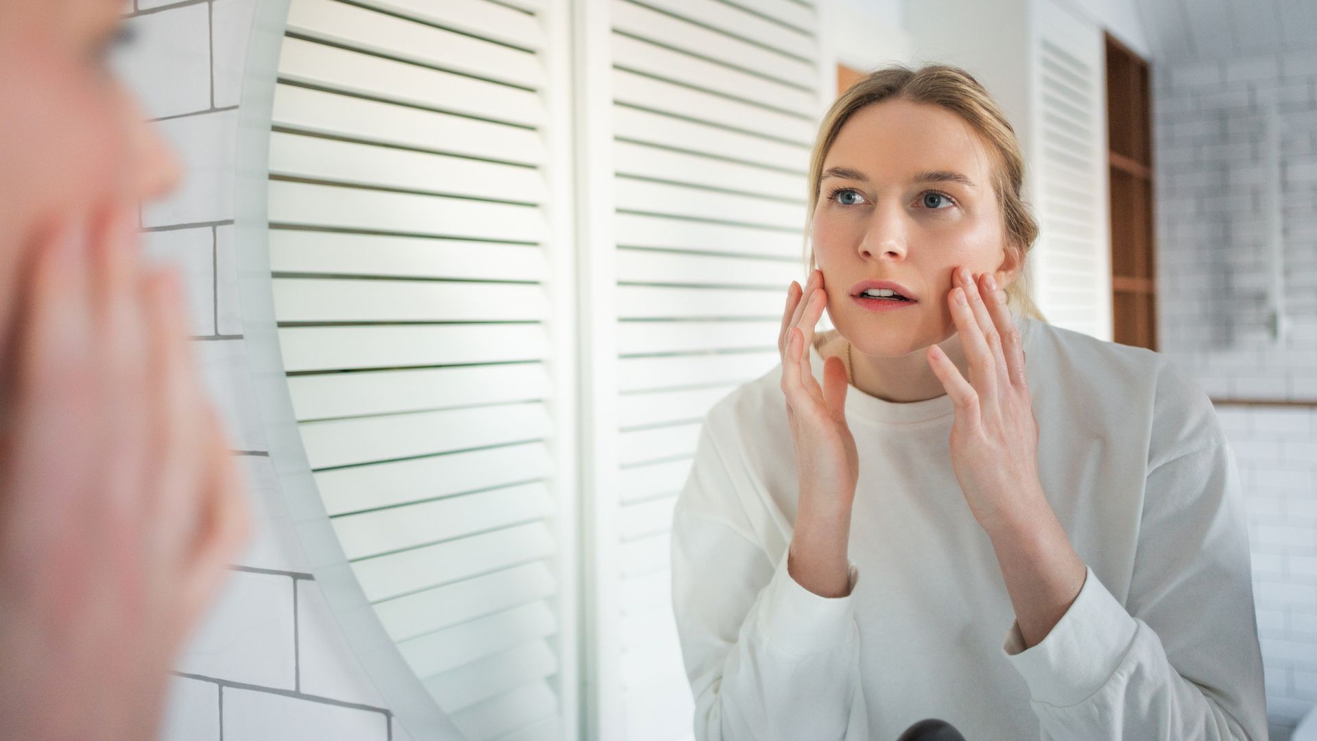 woman looking in mirror