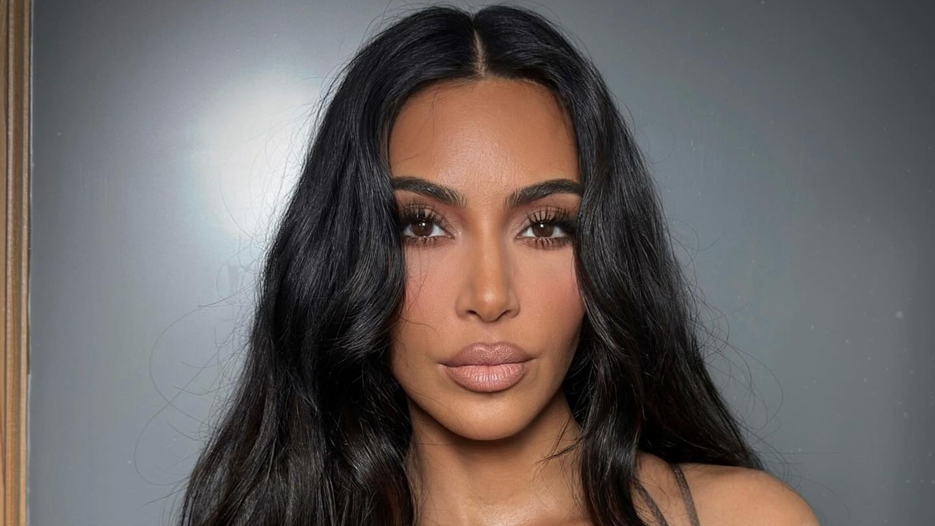 Kim Kardashian poses for a photo in a sheer bodysuit 