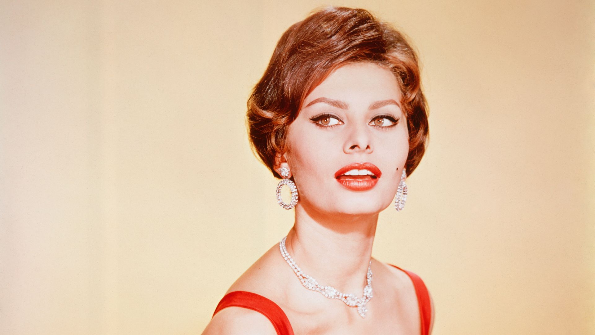 Sophia Loren in 1964 wearing a red dress 