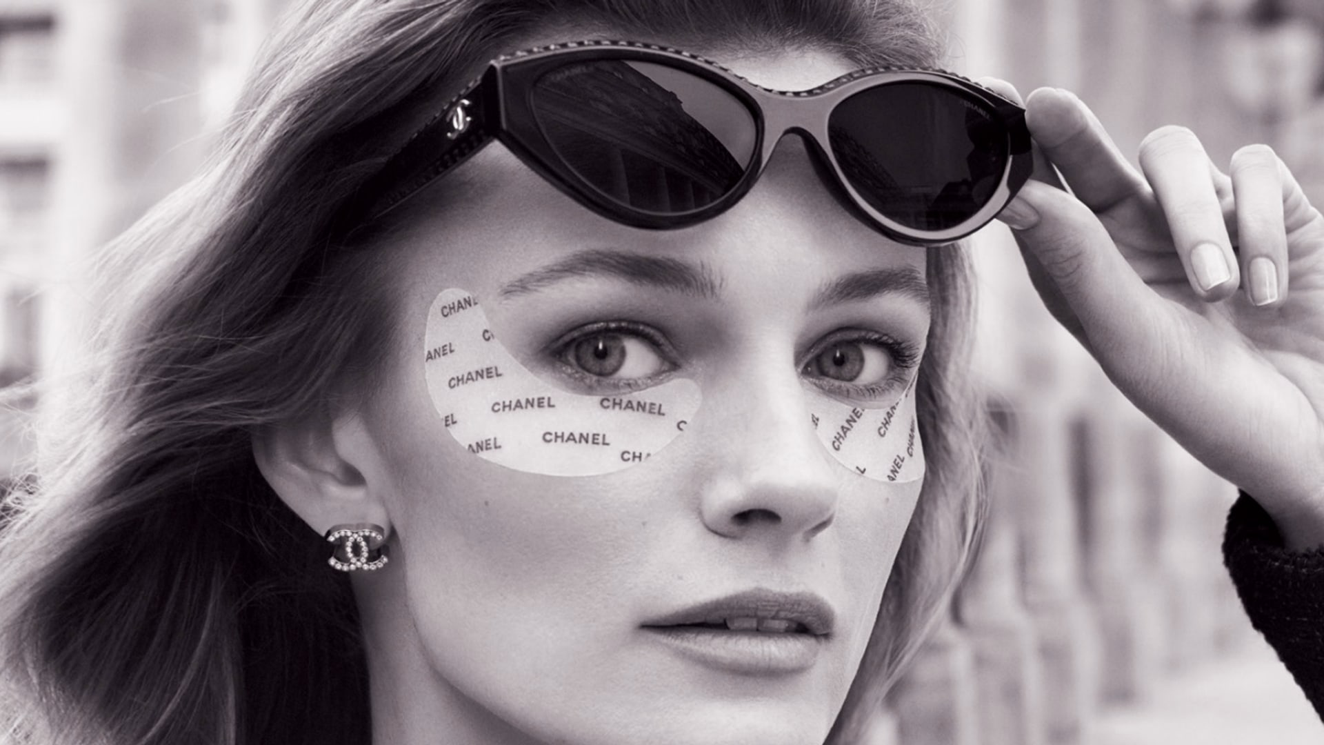 a woman wearing chanel eye patches 
