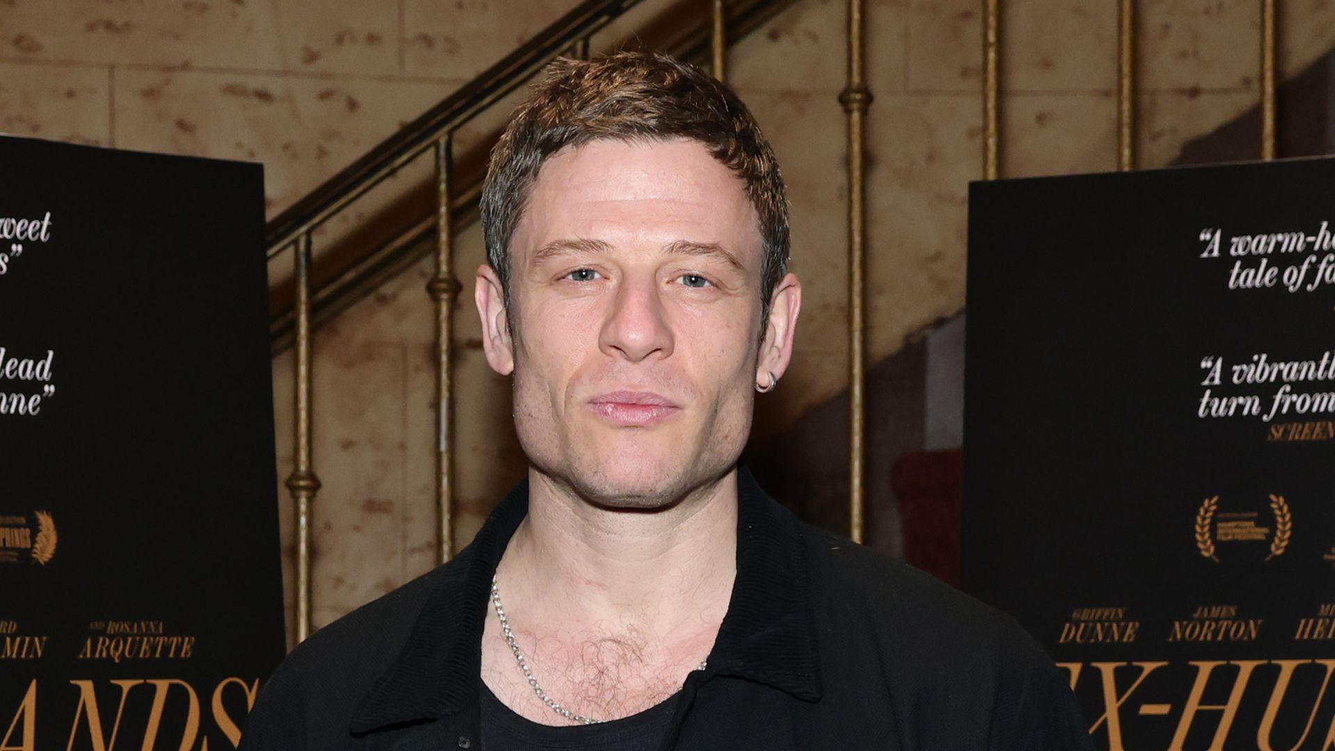 James Norton in front of a staircase