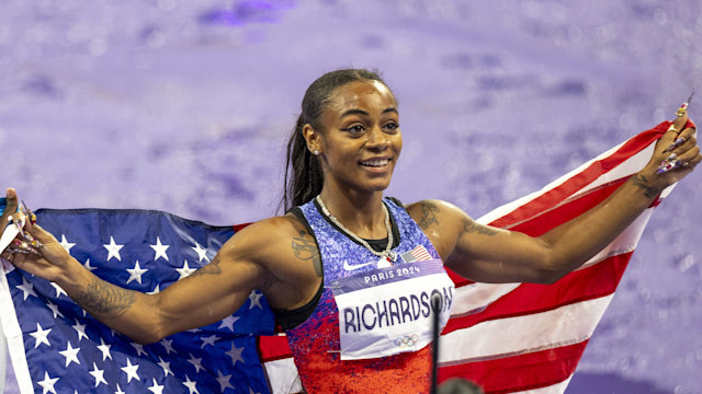 Sha'carri Richardson of USA is seen with the flag of her country after the 100m Women's finals on day eight of the Olympic Games Paris 2024 at Stade de France on August 3, 2024 in Paris, France. (Photo by Aytac Unal/Anadolu via Getty Images)