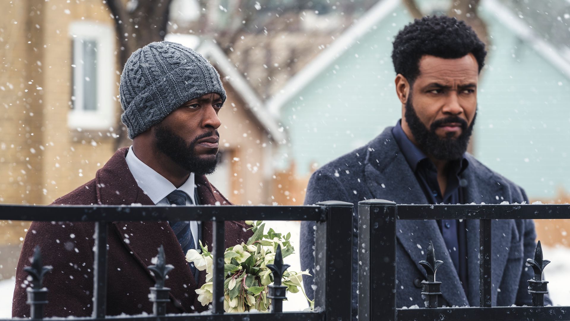 two men standing outdoors in snow