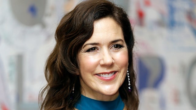 Mary smiling waist up in teal dress