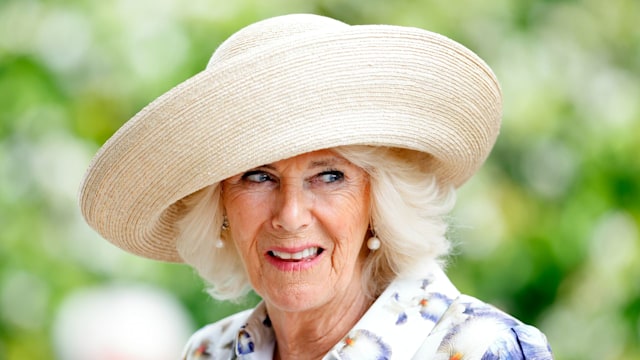 Queen Camilla in a floral dress and straw hat