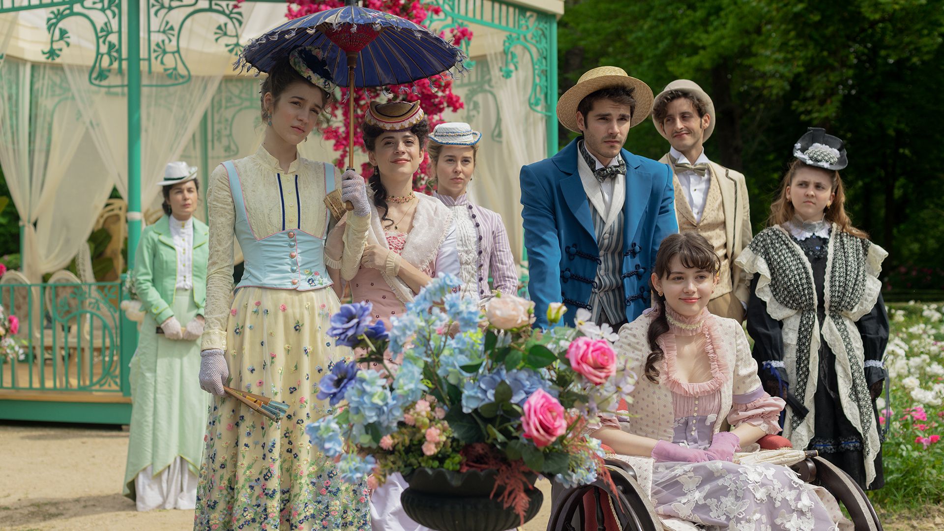 The cast of The Lady's Companion sitting outside in a still from the show