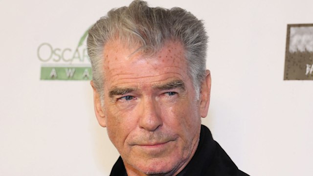 Pierce Brosnan in a black coat