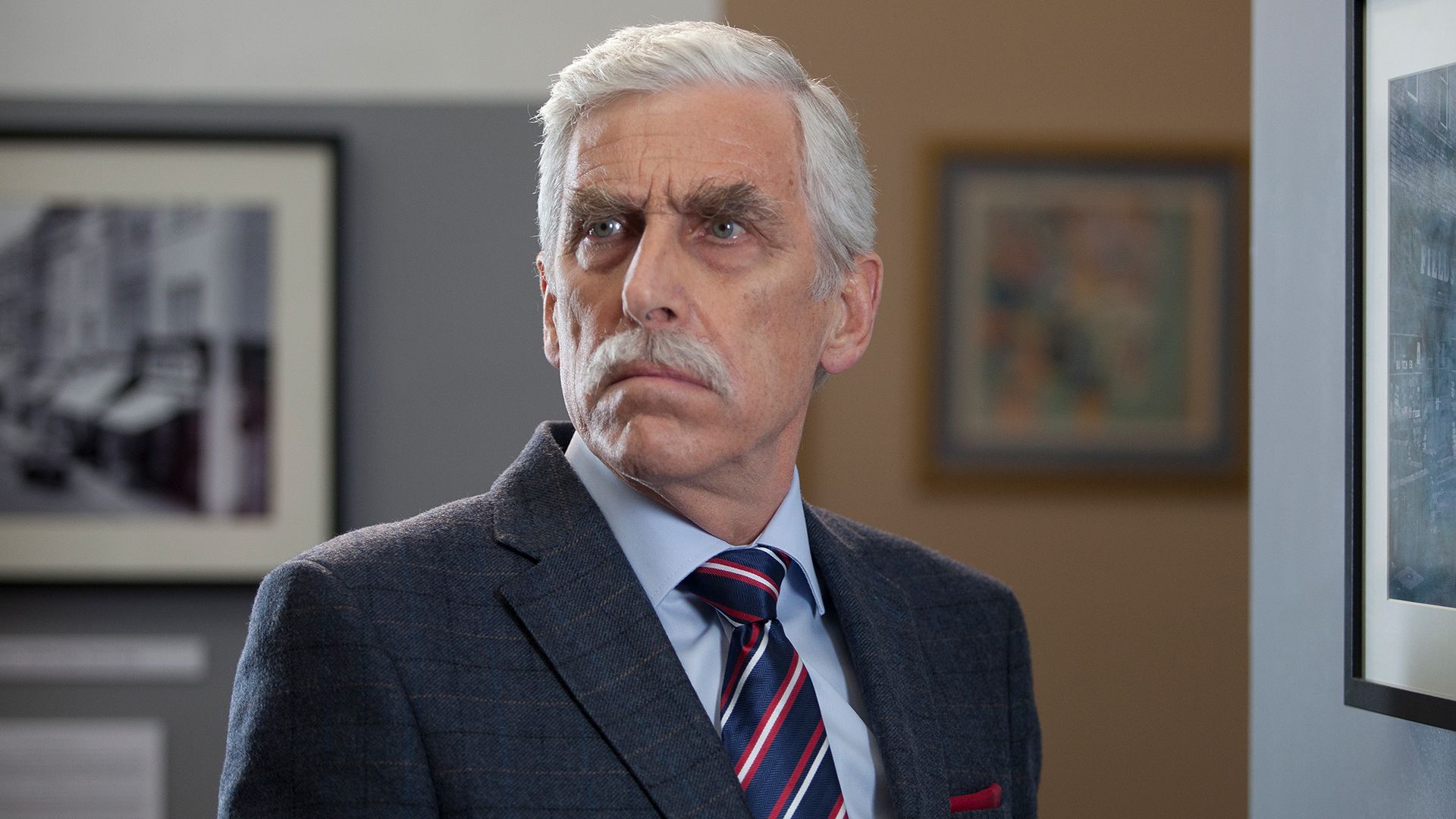 Terrence Hardiman wearing a suit in an episode of Agatha Raisin