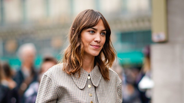 Alexa Chung wears a checkered dress, outside Stella Mccartney, during Paris Fashion Week 2018