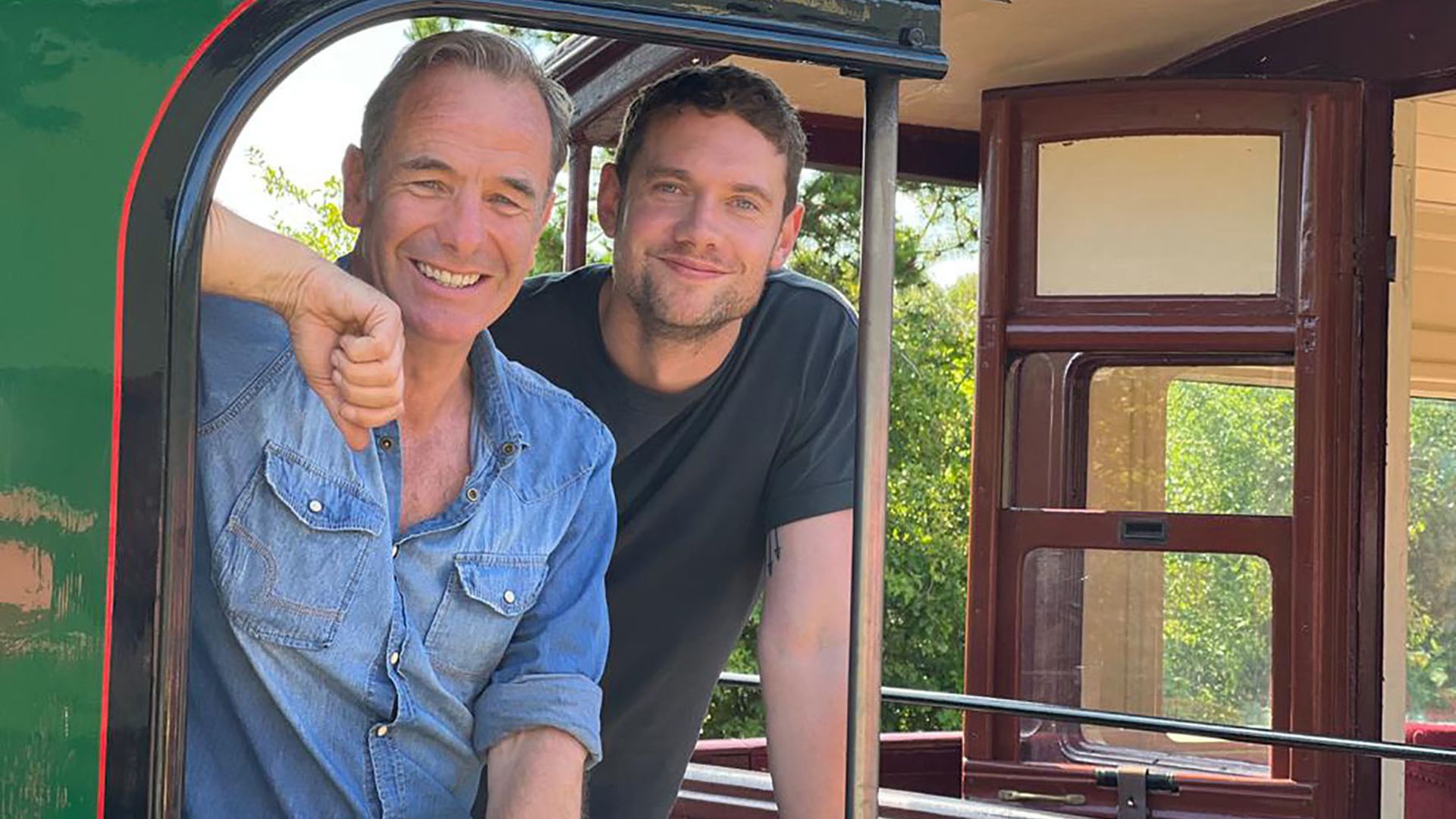 Robson Green and Tom Brittney riding on a steam train