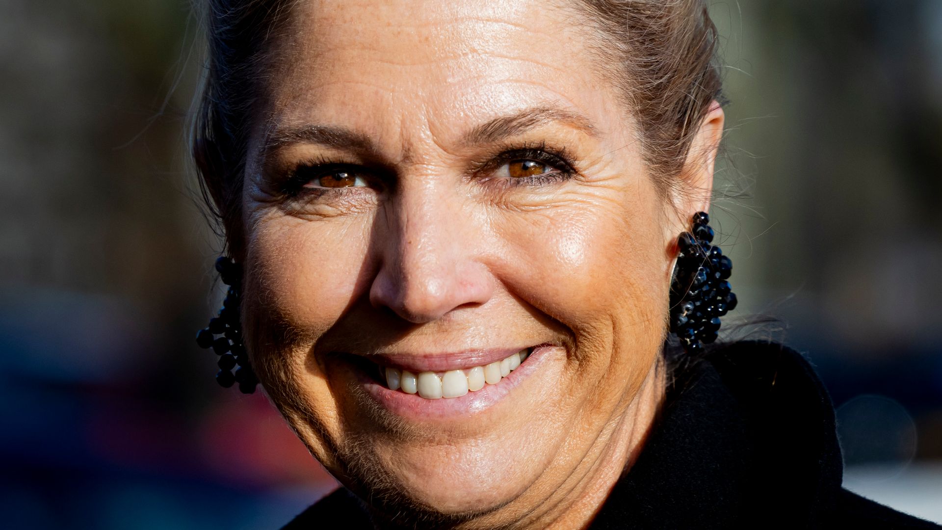Queen Maxima  close up smiling in black coat