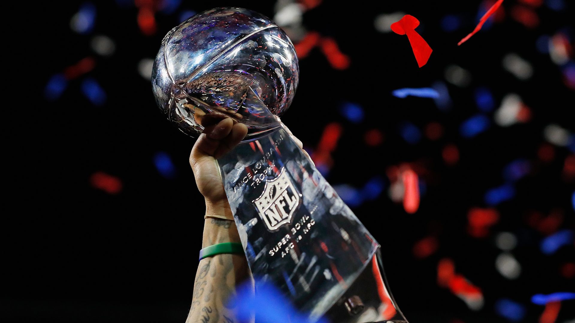 A detail of a New England Patriots player raising the Vince Lombardi Trophy after the Patriots defeat the Los Angeles Rams 13-3 during Super Bowl LIII at Mercedes-Benz Stadium on February 3, 2019 in Atlanta, Georgia.