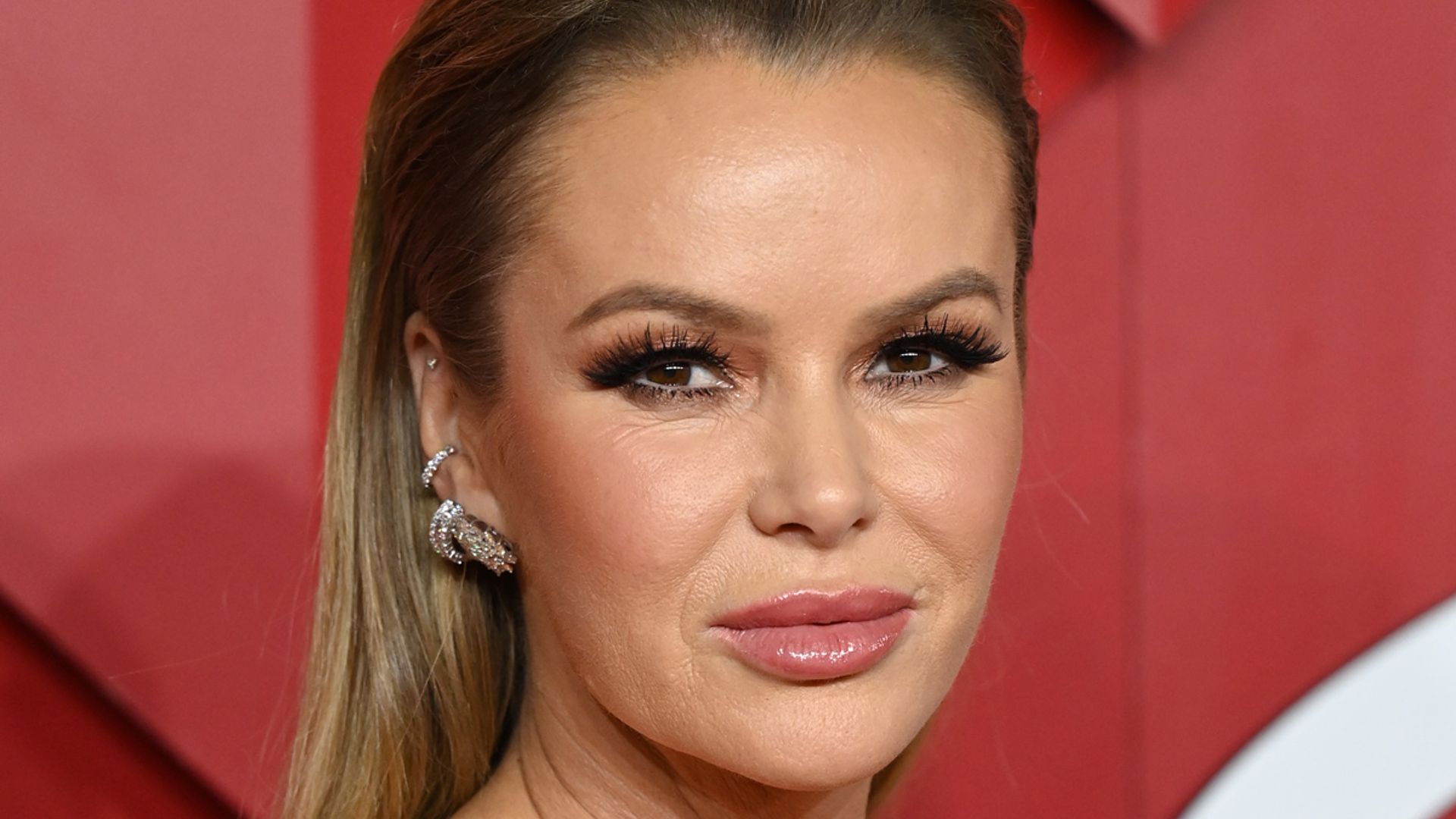 Amanda Holden opts for an eye-catching look in a pink trouser suit and  heels