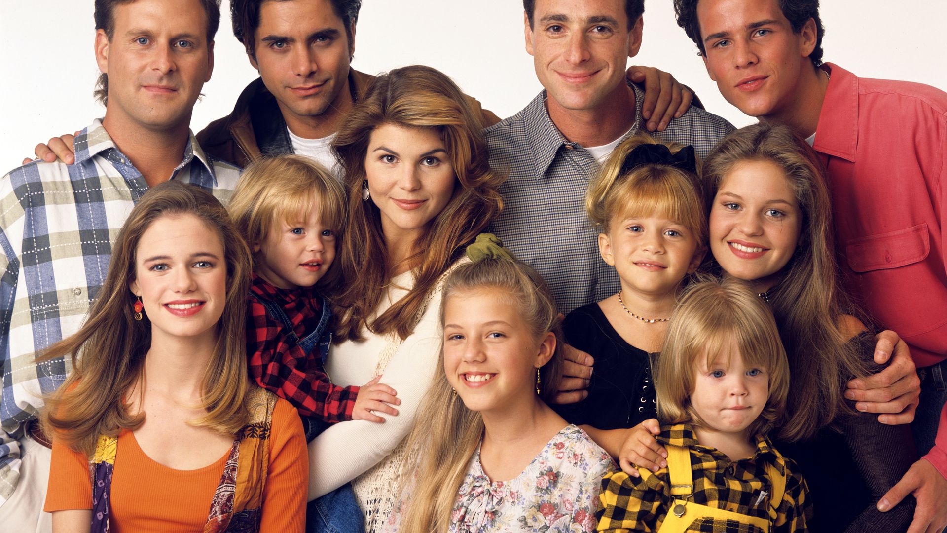 Pictured, from left: Dave Coulier (Joey), Andrea Barber (Kimmy), John Stamos (Jesse), Blake Tuomy-Wilhoit (Nicky), Lori Loughlin (Rebecca), Jodie Sweetin (Stephanie), Bob Saget (Danny), Ashley Olsen (Michelle), Dylan Tuomy-Wilhoit (Alex), Candace Cameron (D.J.), Scott Weinger (Steve) on Full House, 1993