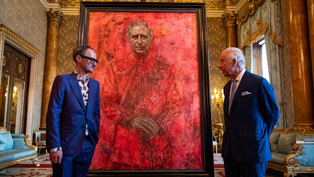 Artist Jonathan Yeo and King Charles III stand in front of the portrait of the King Charles III by artist Jonathan Yeo 