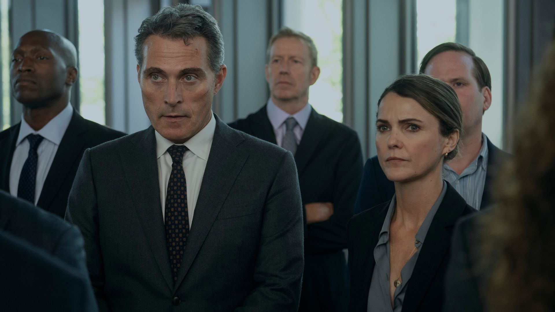 man and woman standing in crowded room