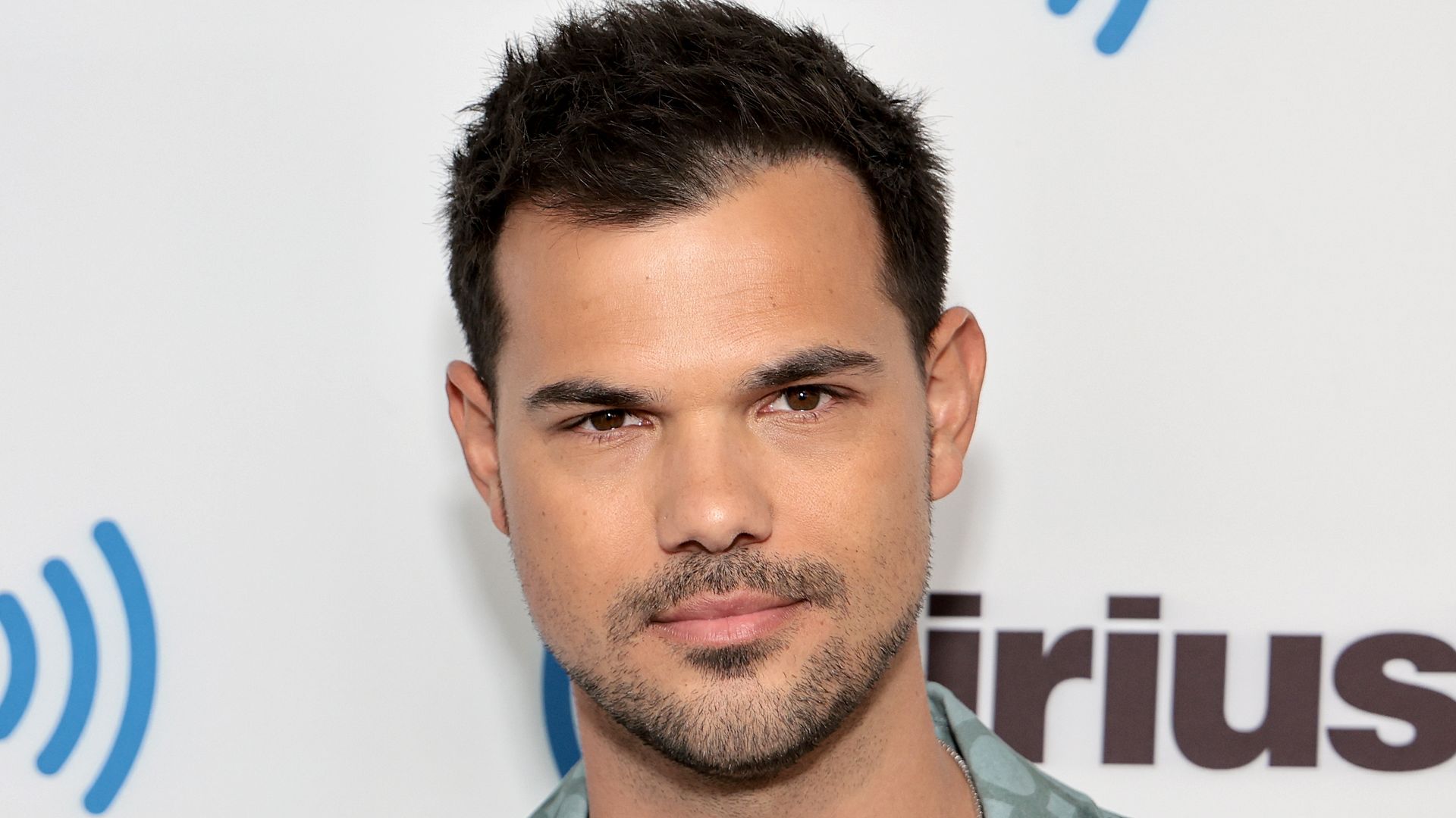 Taylor Lautner in a green shirt 