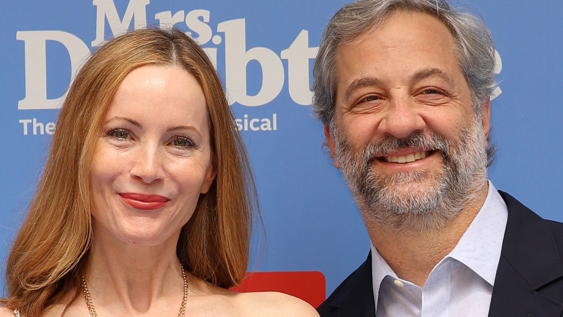 Leslie Mann in a striped crop top and black trousers with her husband Judd Apatow 