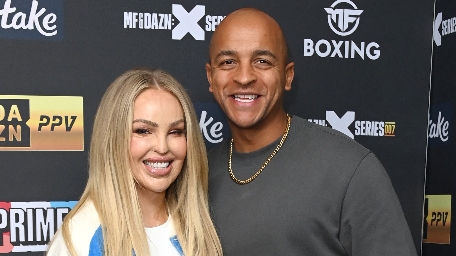 Katie Piper in white and blue jacket with Richard Sutton in a grey jumper
