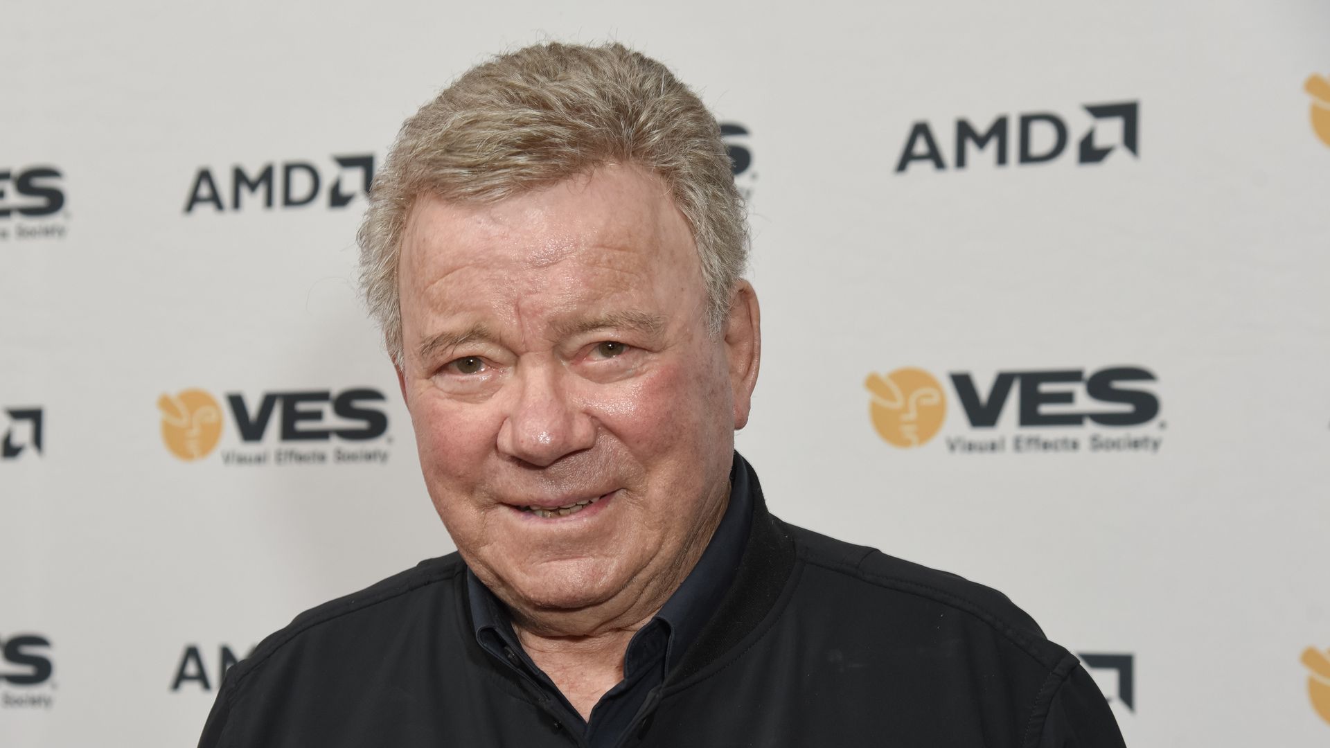 william shatner in black shirt on red carpet