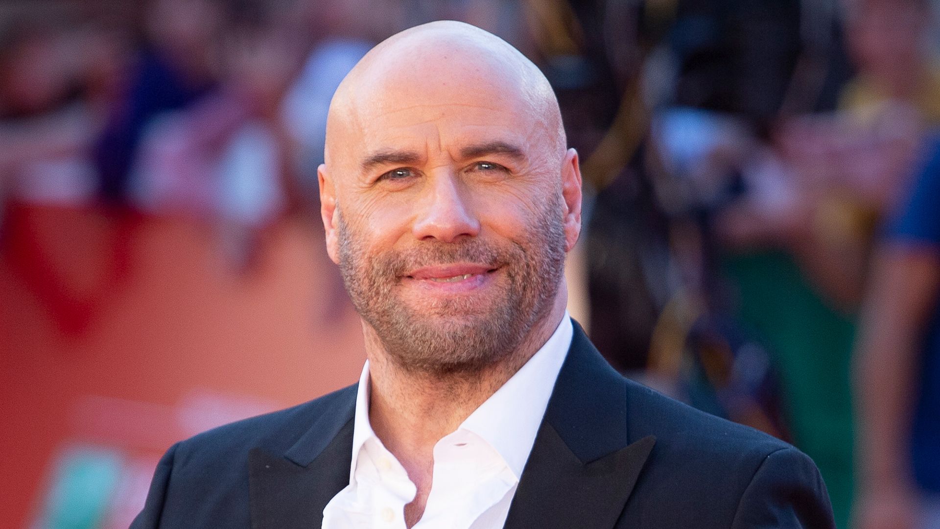 John Travolta posing on the red carpet at the Rome Film Festival in 2022