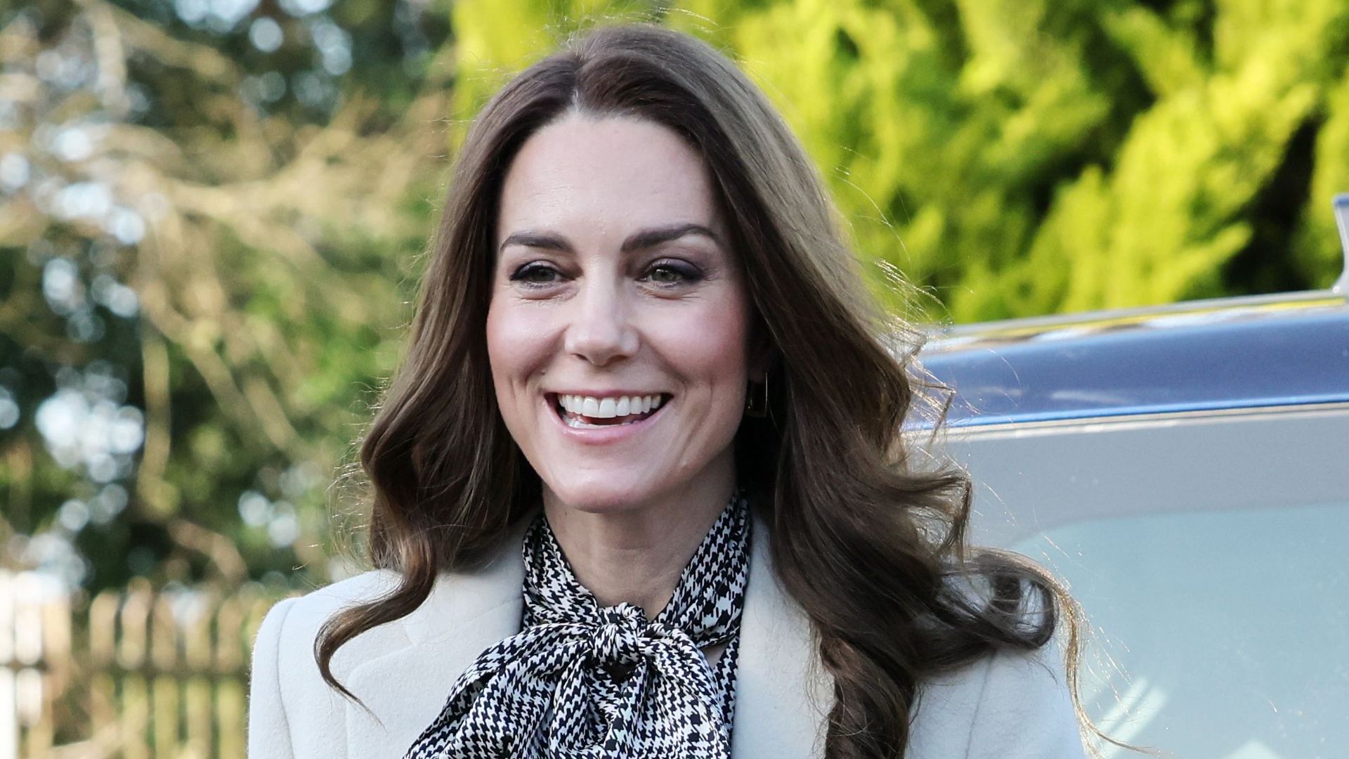 Catherine smiling in check dress 