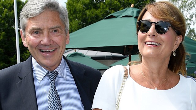 Michael Middleton in a suit with Carole Middleton in a white dress and sunglasses