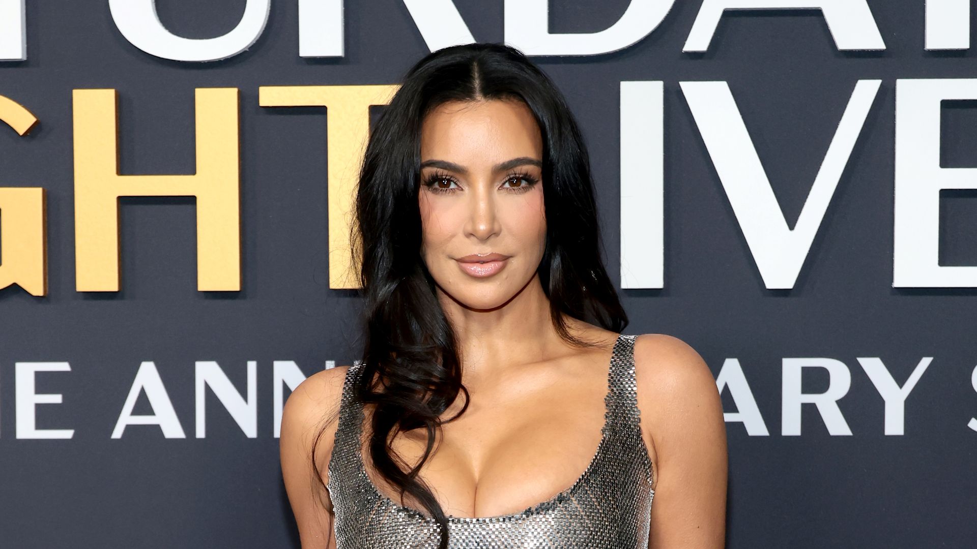 Kim Kardashian is a scene stealer in plunging metallic gown and killer heels for SNL