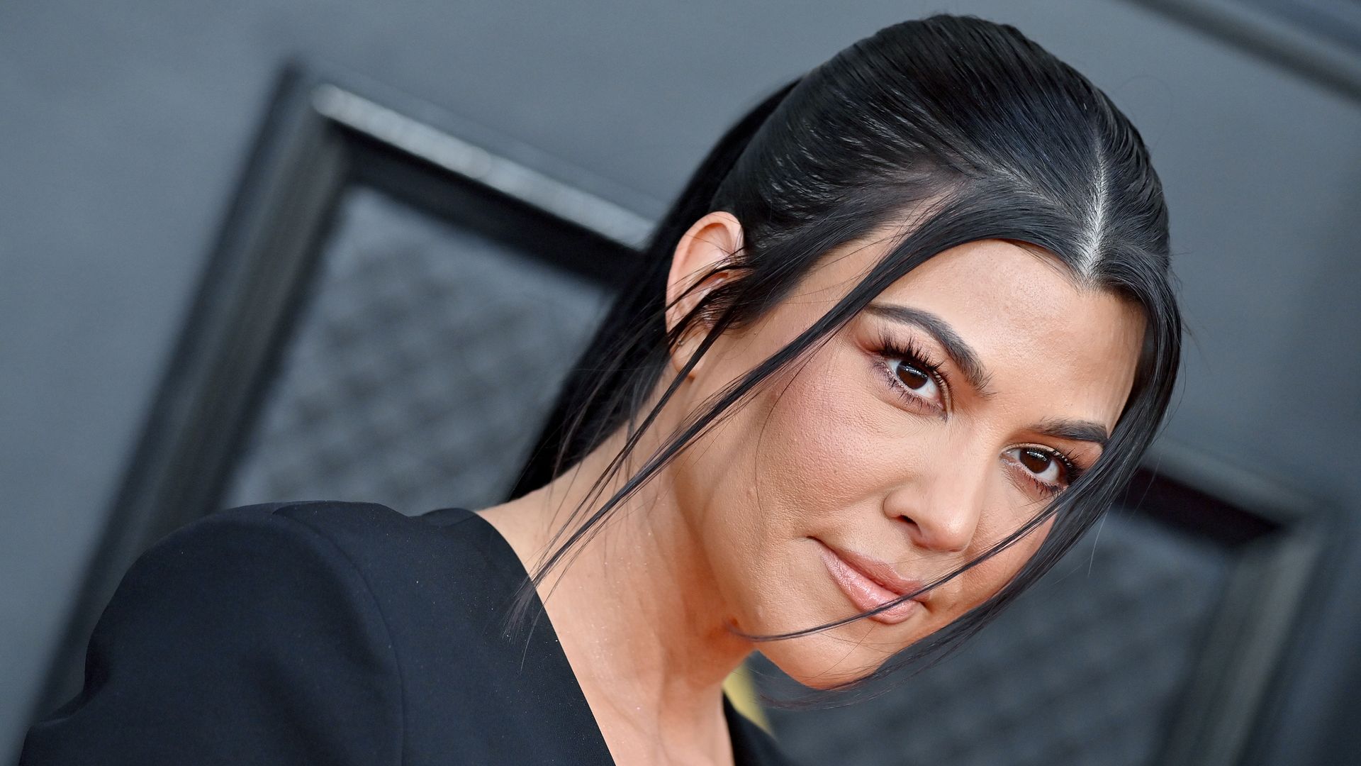 Kourtney Kardashian in black on red carpet