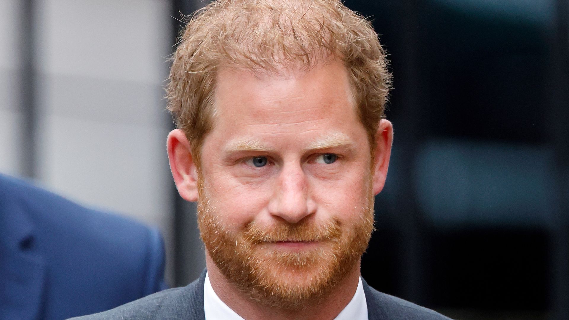 Prince Harry looking serious in a suit at court in London