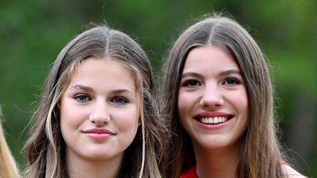 spanish royal sisters posing in orange dresses 