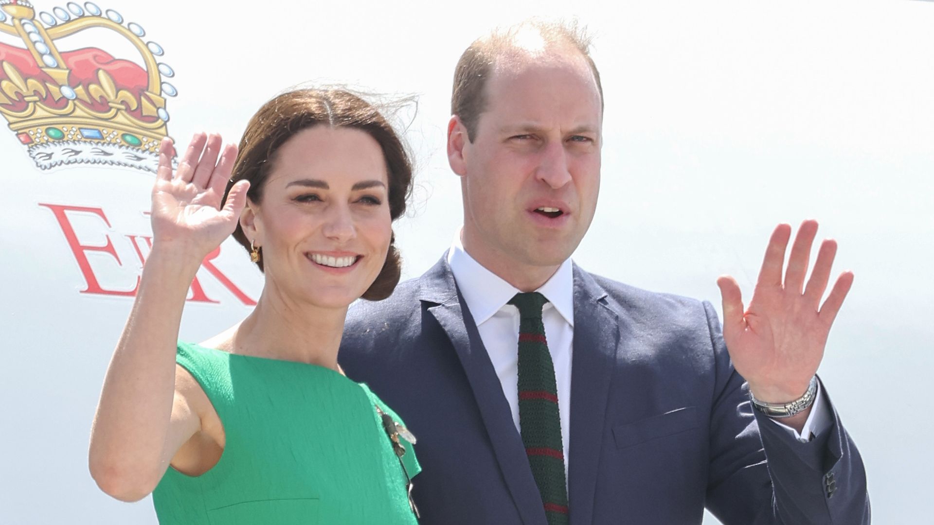 Kate Middleton in green dress smiling from plane with William
