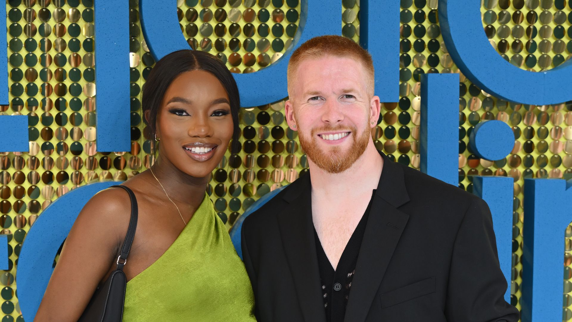Chyna Mills in green and Neil Jones in black at premiere