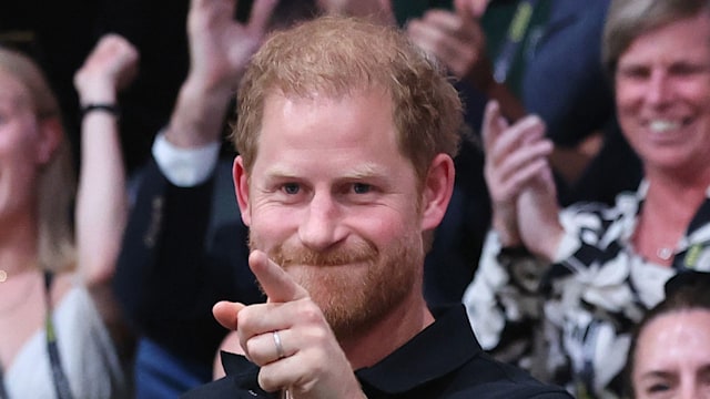 Prince Harry jabbing his finger with an unimpressed expression