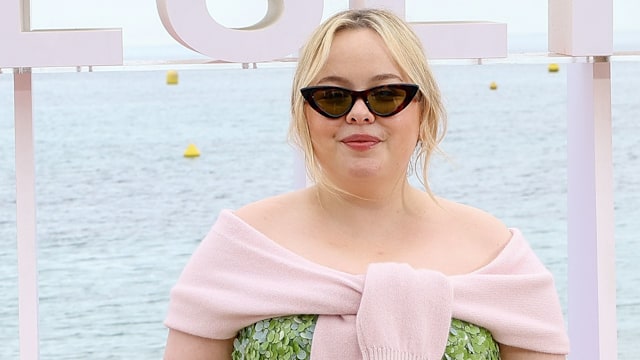 Nicola Coughlan attends the "Prix Konbini de l'Engagement" Photocall on Day Five during the 8th Canneseries International Festival at Palais des Festivals on April 28, 2025 in Cannes, France in a green dress and knit cardigan