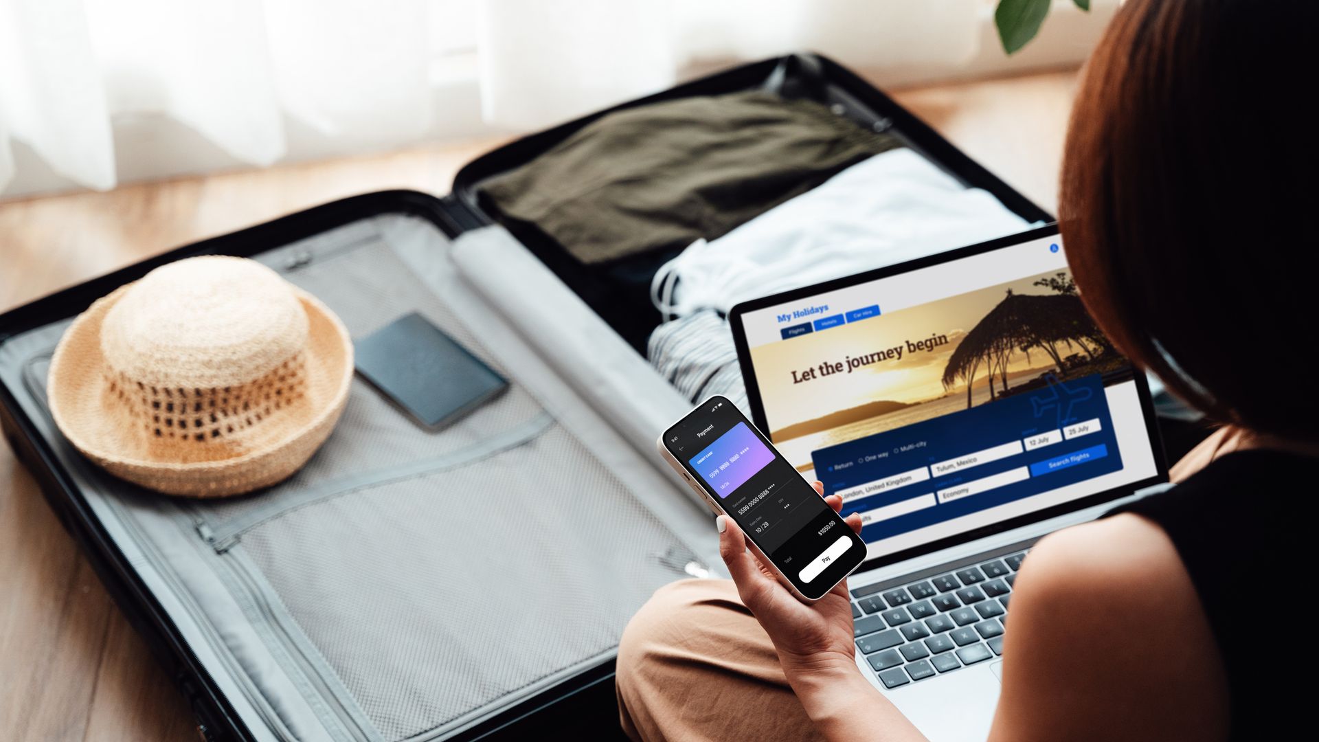 Young woman booking flight and hotel online with laptop and smartphone. Business and leisure travel.