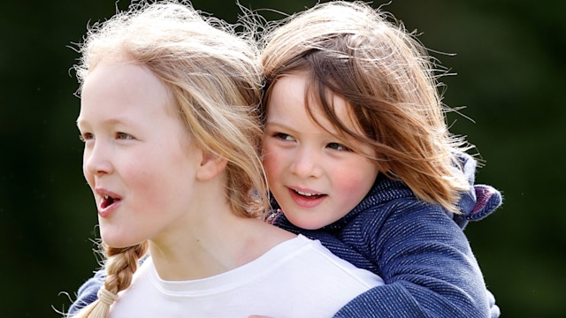 mia tindall and savannah phillips smiling in a close up photo