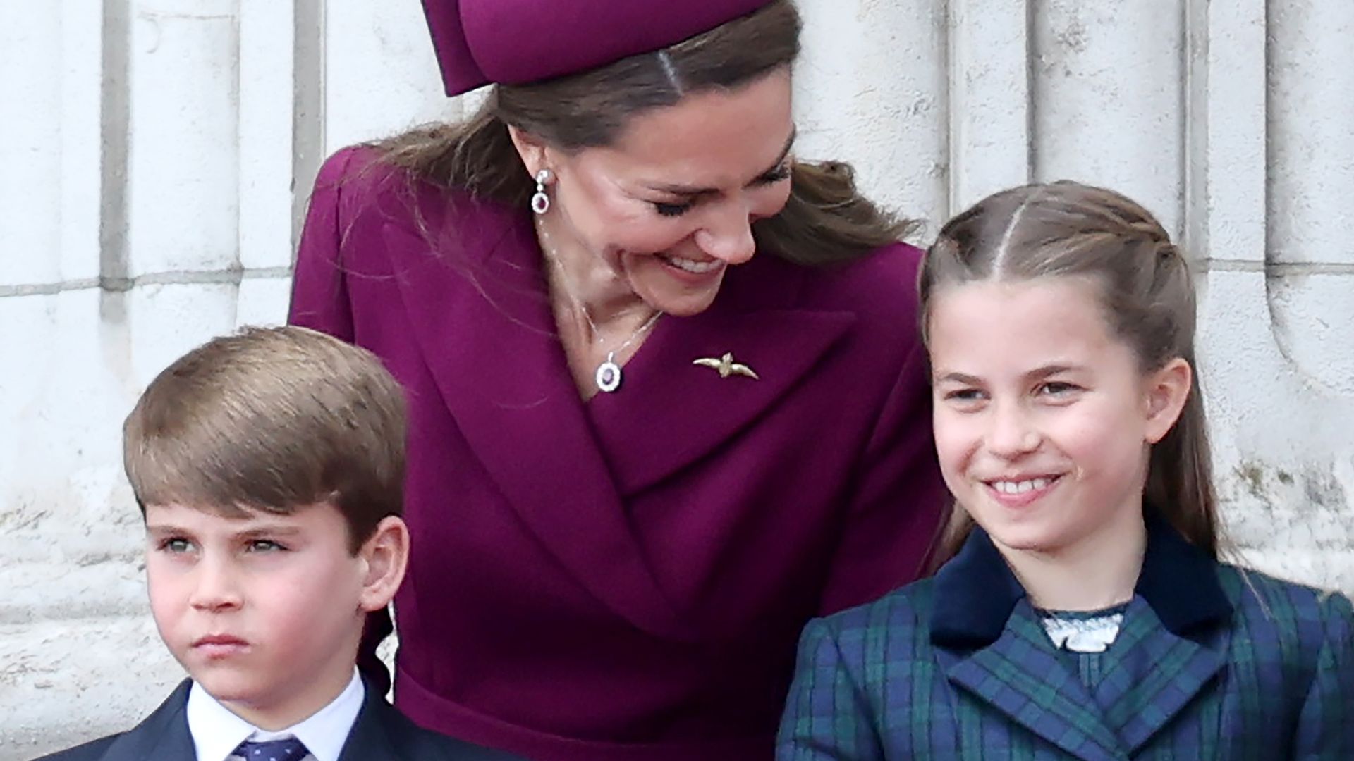princess kate leaning down to talk to charlotte and louis