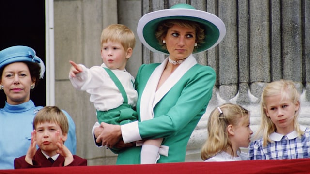 Diana, Princess of Wales, holding a young Prince Harry in her arms as she watches Trooping the Colour with Prince William, Lady Rose Windsor, Lady Davina Windsor and Princess Margaret from the balcony of Buckingham Palace  (Photo by Tim Graham Photo Library via Getty Images)