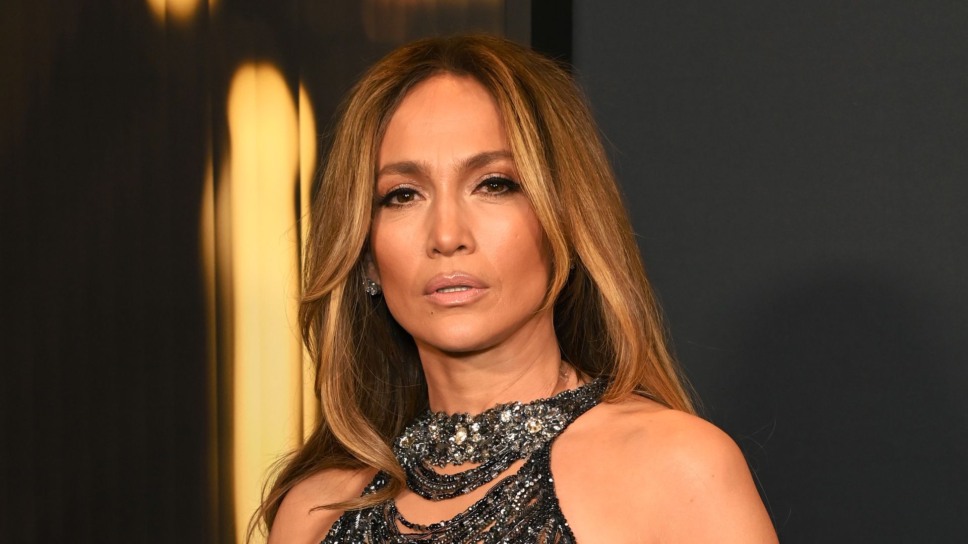 Jennifer Lopez styles a ruffled mini skirt and blazer with nothing underneath